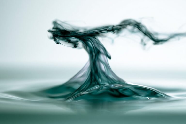 Dark ink wisp rising and clearing above bright water