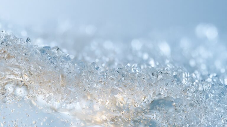 Two crystal forms dissolving at different rates in clear water