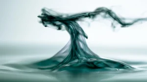 Dark ink wisp rising and clearing above bright water